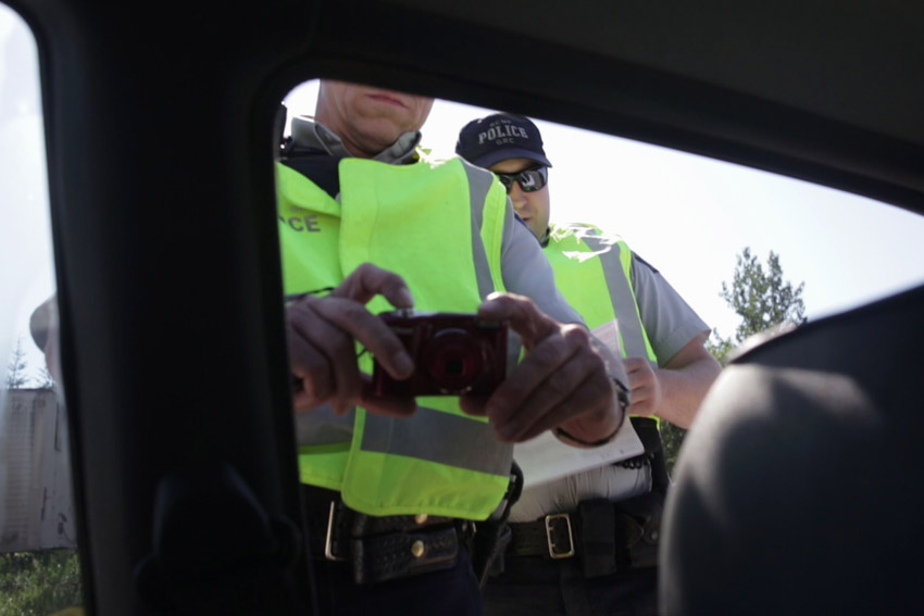 RCMP officers photograph me entering Unist'ot'en territory, July 2016.